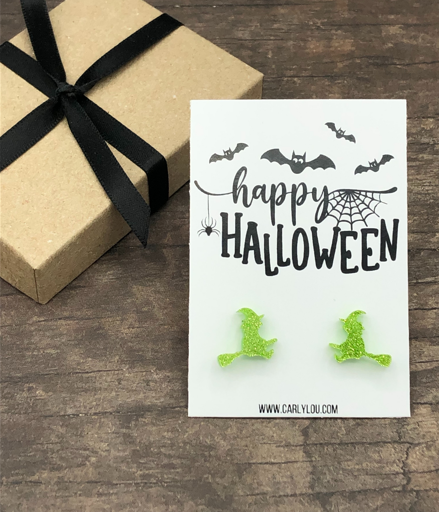 green glitter witch on a broom earrings
