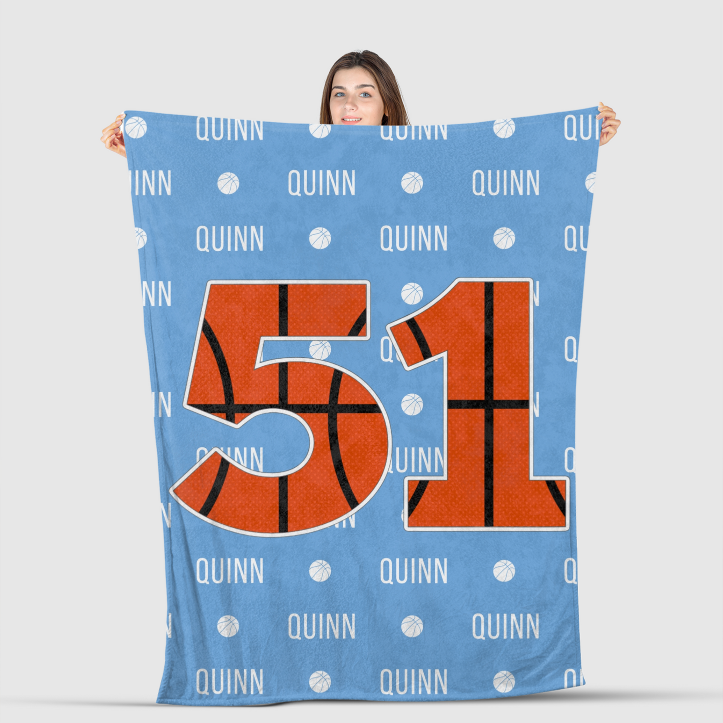 girl holding basketball blanket with custom name and number