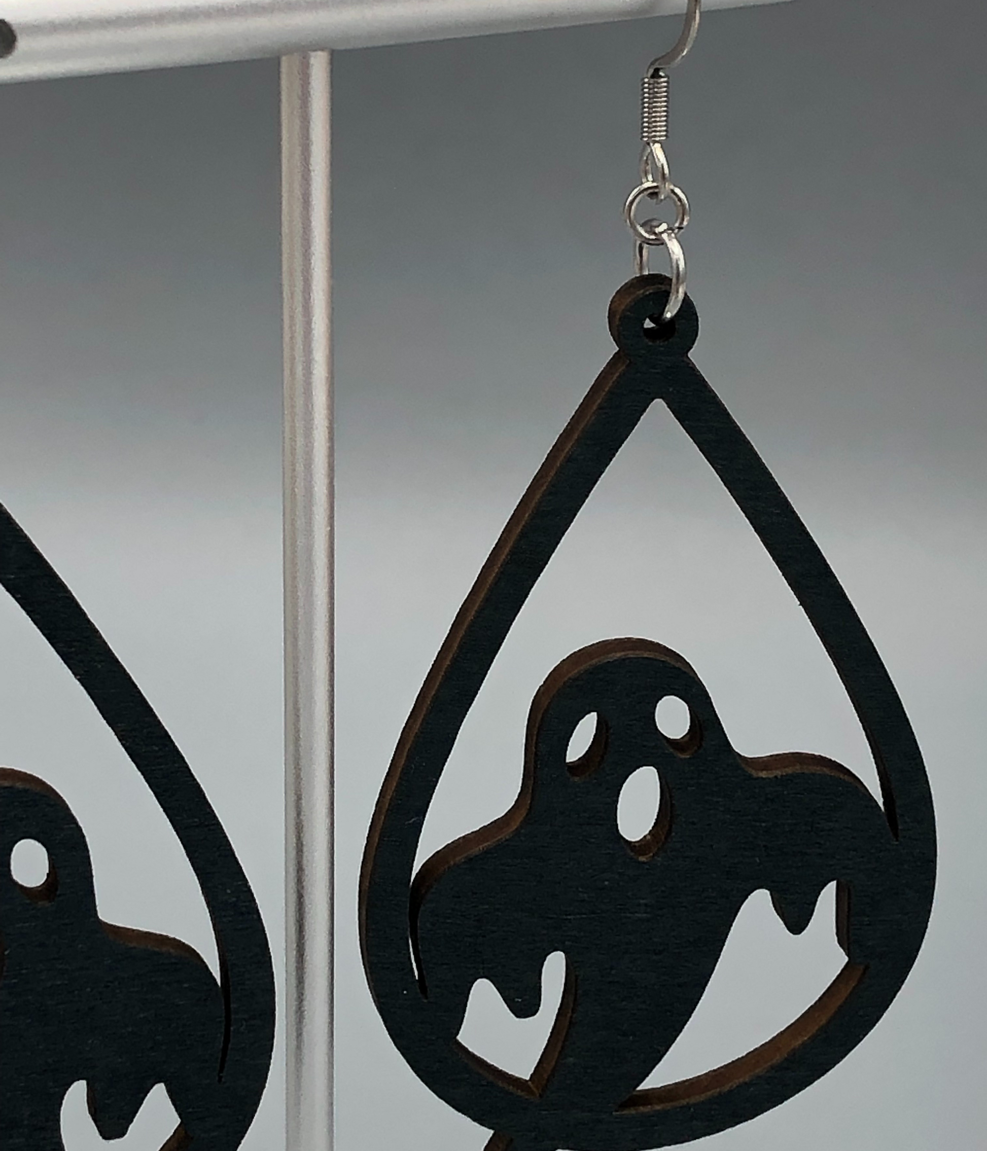black ghost wooden dangle earrings closeup