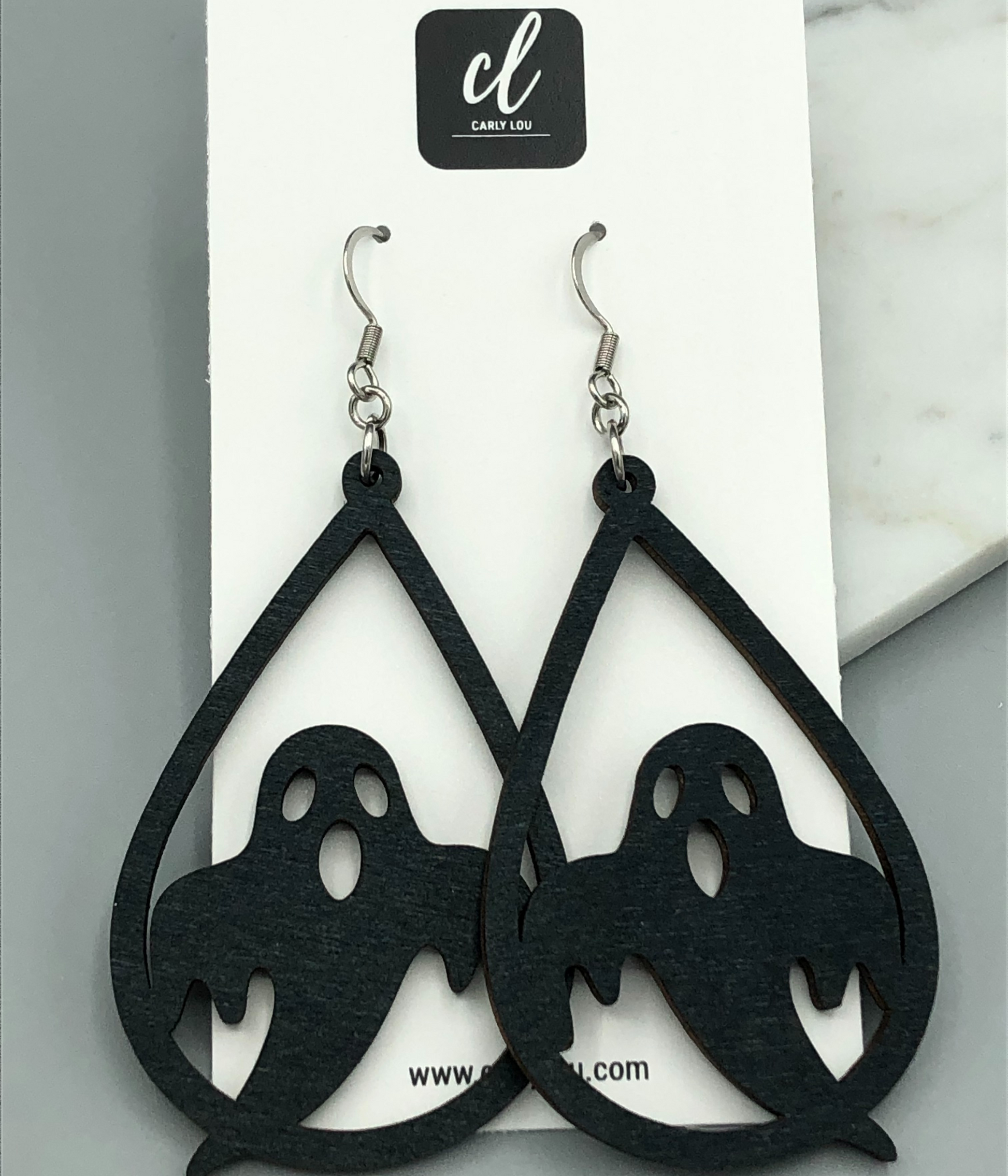 black ghost wooden dangle earrings on card