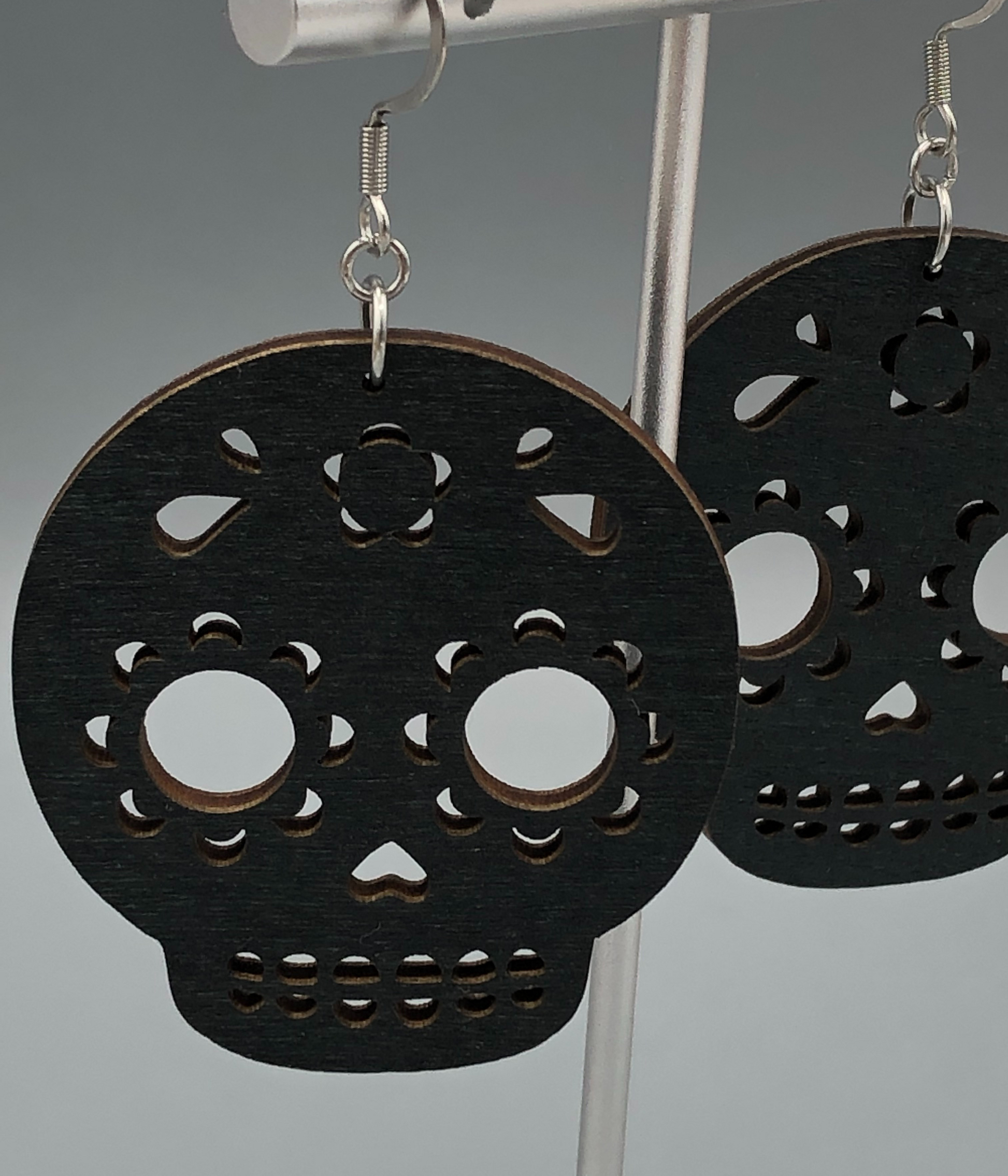 Skeleton wood earrings closeup shot of one earring